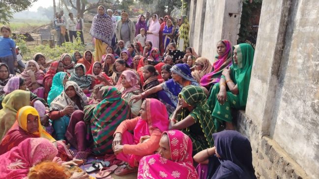 Crowd of women at the house after the murder of the child